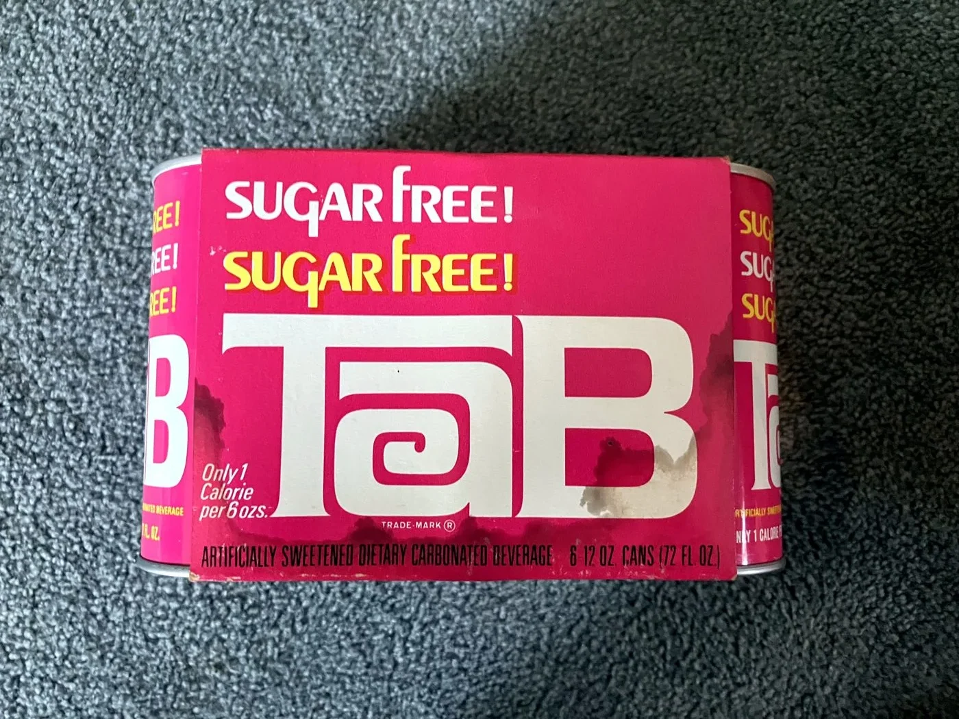A pink TaB six-pack carrier box with sugar free repeated above the logo, from Knut Simonson's archive.